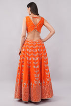 Rust orange raw silk embellished Lehenga choli.