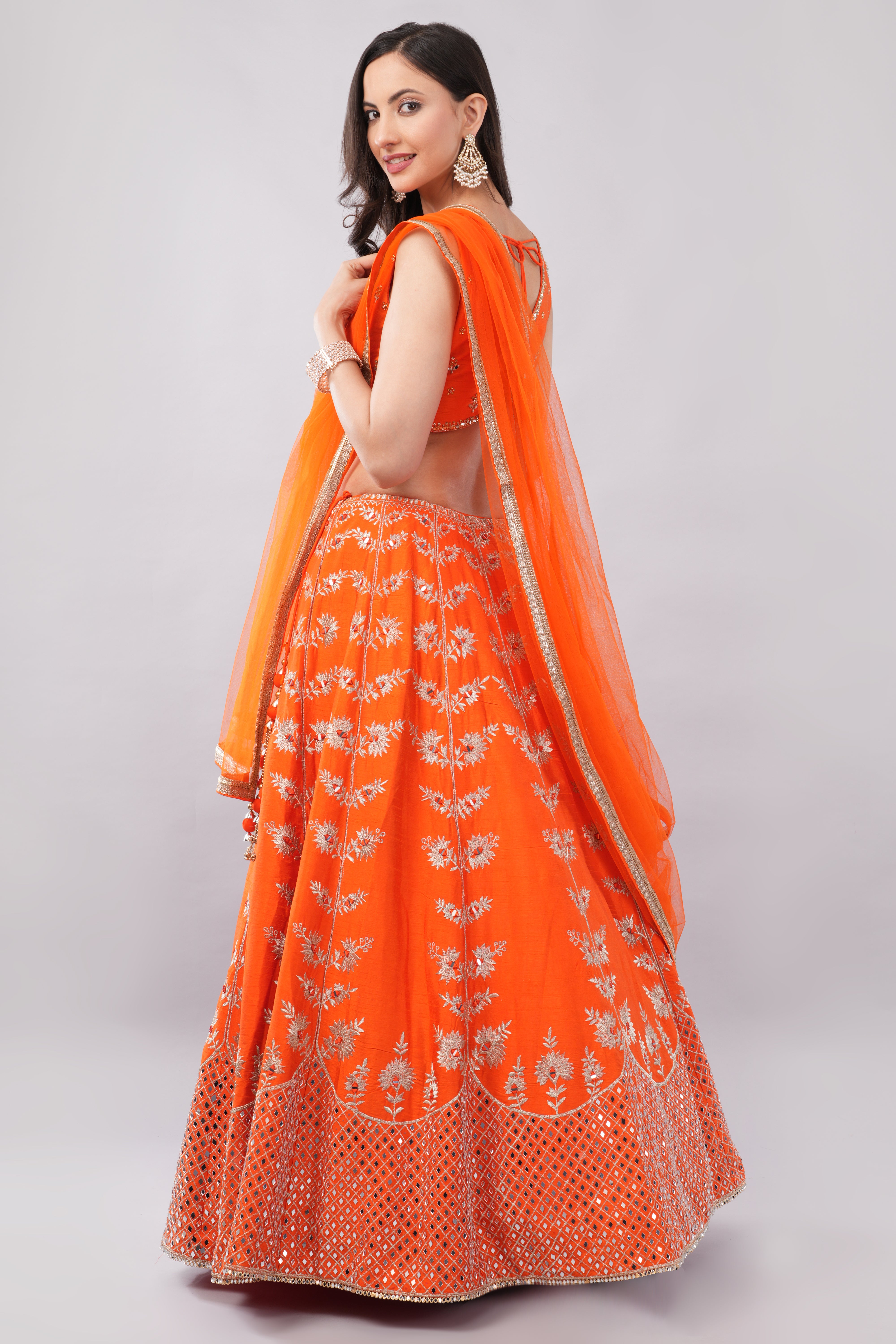 Rust orange raw silk embellished Lehenga choli. Secondary image