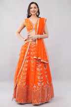 Rust orange raw silk embellished Lehenga choli.
