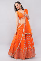 Rust orange raw silk embellished Lehenga choli.