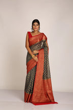Saree in ash gray and red with resham and zari on tissue