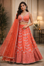 Rust orange raw silk embellished Lehenga choli.